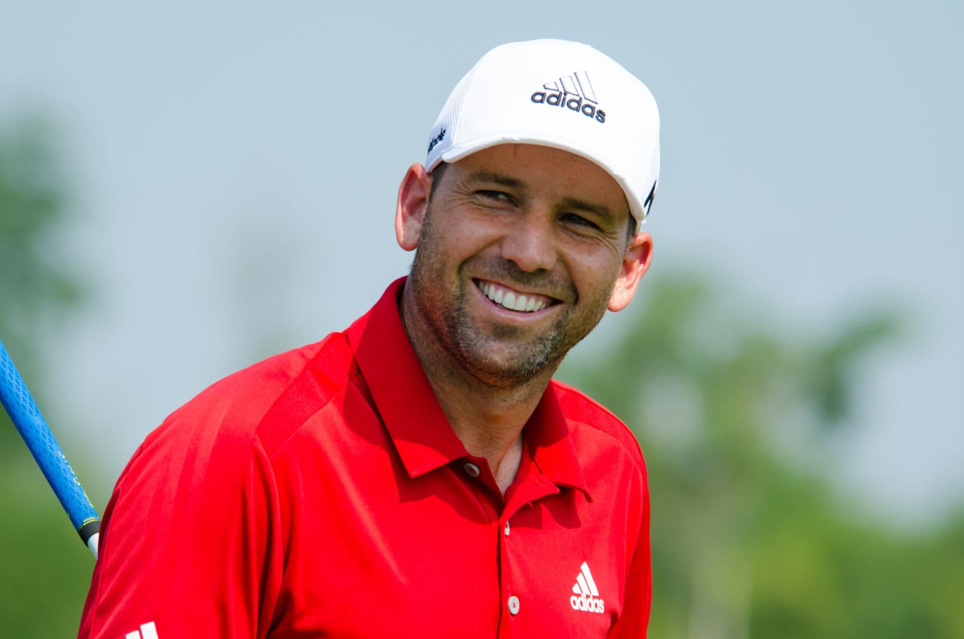 Sergio Garcia smiling on a golf course