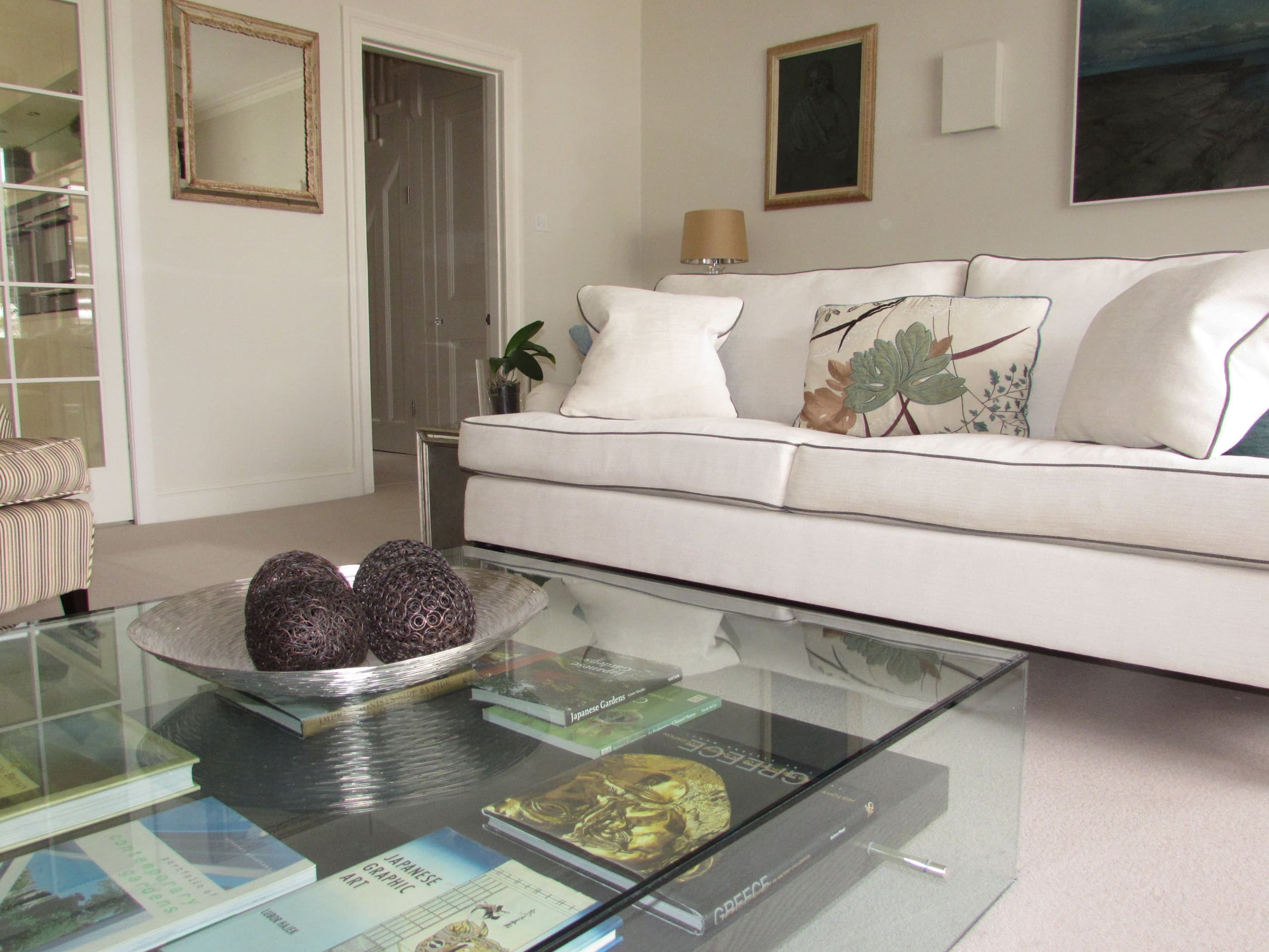 Living room with sofa, coffee table ornaments and books