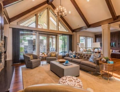 High vaulted ceilings in an open plan living room opening to the kitchen