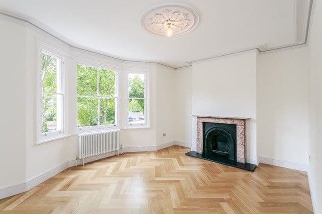 Front reception room with fireplace and bay window