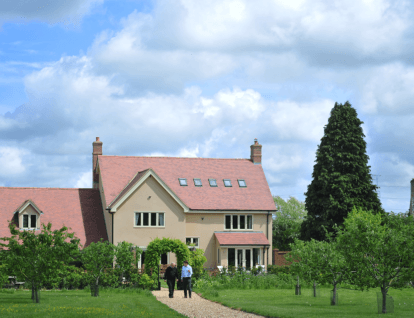 Large country home with a long pathway towards the house